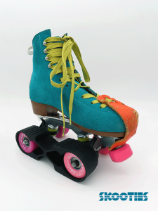 The photo shows a black Skootie is looped over the inside wheels of a left foot, turquoise skate boot. The wheels are pink and purple, with an orange toe tip protector and gold laces.
